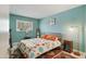 Bright bedroom featuring a large window and colorful mid-century modern decor at 1407 E Laguna Dr, Tempe, AZ 85282