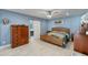 Cozy bedroom with tile floors, a barn door leading to the bathroom, and modern decor at 1407 E Laguna Dr, Tempe, AZ 85282