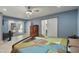Comfortable bedroom with tile floors, pool views, and barn door that leads to the modern bathroom at 1407 E Laguna Dr, Tempe, AZ 85282
