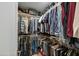 Walk-in closet featuring shelving and clothing racks, offering ample storage space at 1407 E Laguna Dr, Tempe, AZ 85282