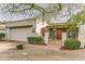 Charming single-story home with white brick, desert landscaping, and gated front entry at 1407 E Laguna Dr, Tempe, AZ 85282