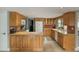 Well-lit kitchen featuring wooden cabinets, an island, and modern appliances at 1407 E Laguna Dr, Tempe, AZ 85282