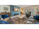 Cozy living room with fireplace, stylish furniture, and a view to the back patio at 1407 E Laguna Dr, Tempe, AZ 85282