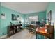A well-lit home office with built in shelving, a comfortable chair and dual monitor desktop at 1407 E Laguna Dr, Tempe, AZ 85282
