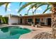 Beautiful outdoor living space with a sparkling pool and covered patio area at 1407 E Laguna Dr, Tempe, AZ 85282