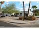 A view of the charming single story home with mature trees and well manicured landscaping at 1407 E Laguna Dr, Tempe, AZ 85282