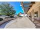 Inviting covered back patio offers a charming space for outdoor living, with a pergola and view of the landscaped backyard at 14617 W Windcrest Dr, Sun City West, AZ 85375