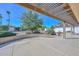 Covered patio overlooking desert landscaping, a relaxing outdoor retreat with a charming brick retaining wall at 14617 W Windcrest Dr, Sun City West, AZ 85375