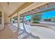 Spacious covered patio overlooks a well-maintained backyard, perfect for relaxing and entertaining guests outdoors at 14617 W Windcrest Dr, Sun City West, AZ 85375