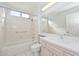 Bathroom featuring a tub, shower, and a large vanity with a mirror at 14617 W Windcrest Dr, Sun City West, AZ 85375