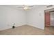 Bright bedroom with ceiling fan and light-colored tile flooring at 14617 W Windcrest Dr, Sun City West, AZ 85375