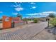 Sun City West entrance with a decorative wall, flowers, and landscaped grounds at 14617 W Windcrest Dr, Sun City West, AZ 85375