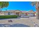 Charming single-story home with desert landscaping, brick accents, and a well-manicured front yard under a clear blue sky at 14617 W Windcrest Dr, Sun City West, AZ 85375