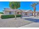Well-maintained single-story home with low-maintenance desert landscaping and mature trees in a sunny neighborhood setting at 14617 W Windcrest Dr, Sun City West, AZ 85375