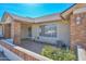 Inviting front porch featuring brick columns, a decorative security door, and a tidy landscaped area at 14617 W Windcrest Dr, Sun City West, AZ 85375
