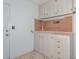 Garage with storage cabinets and pegboard organizer at 14617 W Windcrest Dr, Sun City West, AZ 85375