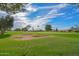 Scenic view of a meticulously groomed golf course with a sand trap and blue skies at 14617 W Windcrest Dr, Sun City West, AZ 85375