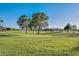 Expansive golf course view featuring manicured greens and mature trees, offering a serene and picturesque backdrop at 14617 W Windcrest Dr, Sun City West, AZ 85375