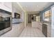 Spacious kitchen with modern stainless steel appliances and tile flooring at 14617 W Windcrest Dr, Sun City West, AZ 85375