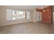 Bright living room with large windows, tile flooring, open floor plan, and neutral paint at 14617 W Windcrest Dr, Sun City West, AZ 85375