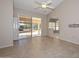 Open-concept living area with sliding door access to the patio and a partial view of an adjacent room at 14617 W Windcrest Dr, Sun City West, AZ 85375