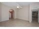 Bright living room featuring an arched doorway, tile floors, and an open concept layout at 14617 W Windcrest Dr, Sun City West, AZ 85375