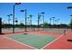 Outdoor pickleball courts featuring vibrant surfaces and lighting for evening play at 14617 W Windcrest Dr, Sun City West, AZ 85375