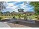 Shaded picnic area with multiple tables surrounded by lush green spaces and trees at 14617 W Windcrest Dr, Sun City West, AZ 85375