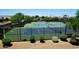 View of well-maintained tennis courts with lush landscaping in a vibrant community at 14617 W Windcrest Dr, Sun City West, AZ 85375