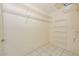 Large walk-in closet featuring wire shelving, tile floors, and plenty of storage space at 14617 W Windcrest Dr, Sun City West, AZ 85375