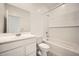Clean bathroom with white subway tiles, a shower-tub combo, and a vanity with modern fixtures at 14968 W Hackamore Dr, Surprise, AZ 85387