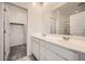 Bathroom featuring double sinks, a large mirror, and a walk-in closet at 14968 W Hackamore Dr, Surprise, AZ 85387
