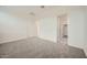 Spacious bedroom with neutral carpet, two doors, and natural lighting at 14968 W Hackamore Dr, Surprise, AZ 85387