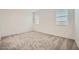 Bright, carpeted bedroom with two windows allowing natural light at 14968 W Hackamore Dr, Surprise, AZ 85387