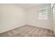 Well-lit bedroom with soft carpet and a window that provides natural light and ventilation at 14968 W Hackamore Dr, Surprise, AZ 85387