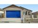 Cozy single-story home with a two-car garage featuring desert landscaping and a welcoming front porch at 14968 W Hackamore Dr, Surprise, AZ 85387