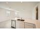 Bright, open-concept kitchen featuring an island with a stainless steel dishwasher and sink at 14968 W Hackamore Dr, Surprise, AZ 85387