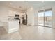 Bright kitchen featuring stainless steel appliances, white cabinets, and a sliding glass door to the backyard at 14968 W Hackamore Dr, Surprise, AZ 85387