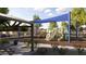 Community playground featuring slides, a shaded picnic area, and safe play surfaces at 14968 W Hackamore Dr, Surprise, AZ 85387