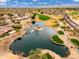 Aerial view of desert community lake and golf course with adjacent luxury housing at 15558 W Big Sky Dr, Surprise, AZ 85374
