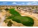 High aerial view of a golf green, community lake, and nearby homes at 15558 W Big Sky Dr, Surprise, AZ 85374