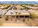 Aerial view showcasing an outdoor living space with three palm trees in front of a single-story house at 15558 W Big Sky Dr, Surprise, AZ 85374