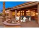 Relaxing backyard with a built-in fire pit, patio area, and outdoor seating, perfect for entertaining at 15558 W Big Sky Dr, Surprise, AZ 85374