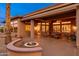 Spacious backyard features a built-in fire pit and large patio area with multiple seating options at 15558 W Big Sky Dr, Surprise, AZ 85374
