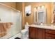 Bathroom featuring a granite vanity and a glass-enclosed shower at 15558 W Big Sky Dr, Surprise, AZ 85374