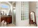 Bathroom featuring a walk-in shower with glass block, granite counters and wood cabinetry at 15558 W Big Sky Dr, Surprise, AZ 85374