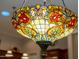 Close-up of a colorful stained glass chandelier, showcasing intricate details and vibrant patterns at 15558 W Big Sky Dr, Surprise, AZ 85374
