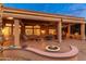 Spacious covered patio with a seating area, dining space, and desert landscaping at 15558 W Big Sky Dr, Surprise, AZ 85374