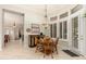 Charming dining area with a round wooden table, built-in cabinet, and ample natural light from the windows at 15558 W Big Sky Dr, Surprise, AZ 85374