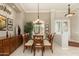 Elegant dining room featuring a glass table, comfortable seating, and a decorative chandelier at 15558 W Big Sky Dr, Surprise, AZ 85374